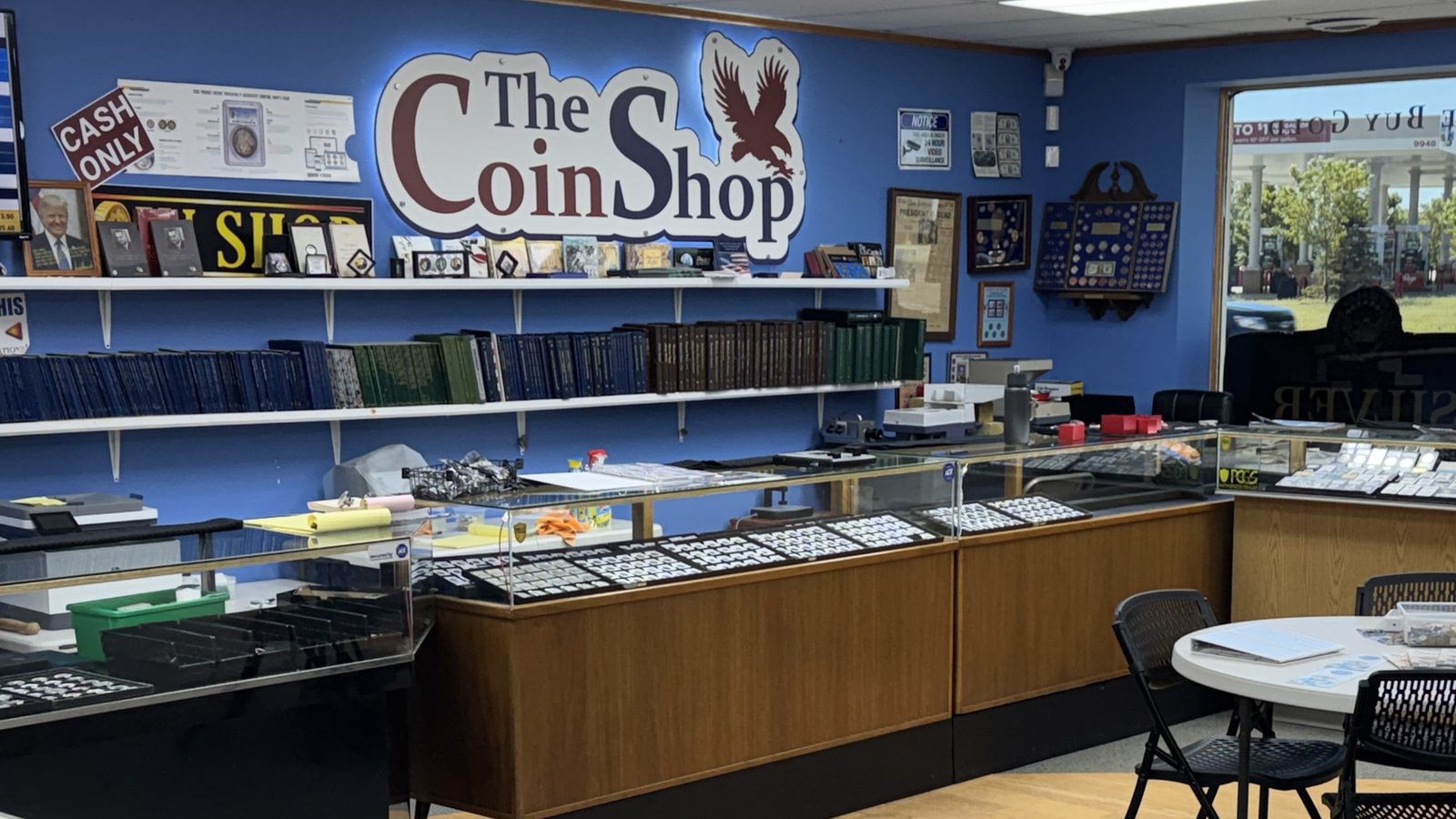 The Coin Shop logo wall and display cases